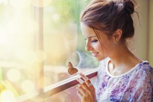 woman looking at a butterfly